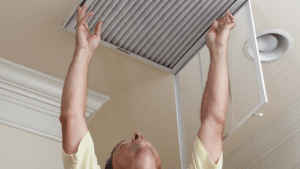 A man changing the house air filter